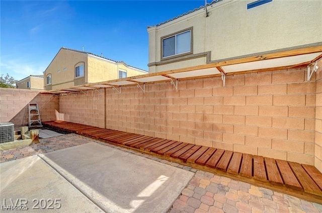 6320 Desert Leaf St Unit 101, North Las Vegas, NV 89081 - fenced backyard with a patio and central air condition unit