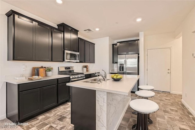 762 Star Estates Ave Unit 0, North Las Vegas, NV 89086 - kitchen featuring appliances with stainless steel finishes, a sink, a kitchen breakfast bar, light countertops, and a center island with sink