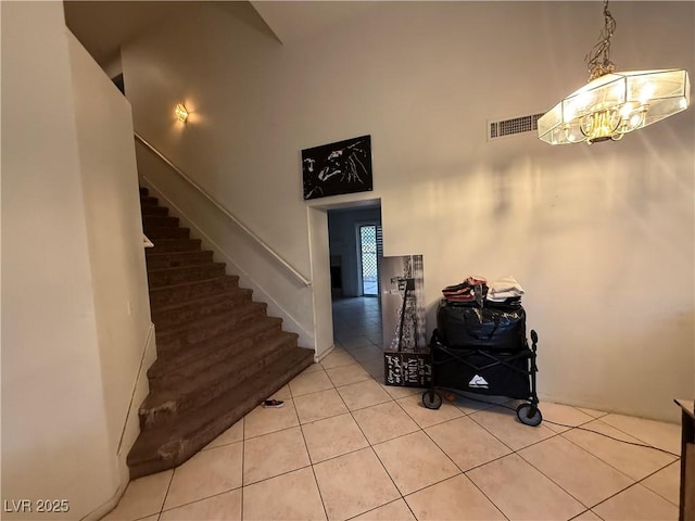 1749 Green Apple Way, Las Vegas, NV 89142 - stairs featuring a high ceiling, tile patterned flooring, and a chandelier