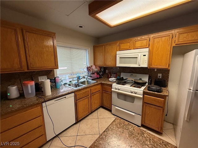 1749 Green Apple Way, Las Vegas, NV 89142 - kitchen featuring white appliances, a sink, decorative backsplash, light tile patterned floors, and brown cabinetry