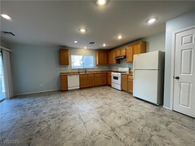 4749 Golden Shimmer Ave, Las Vegas, NV 89139 - kitchen with white appliances, a sink, under cabinet range hood, baseboards, and brown cabinets