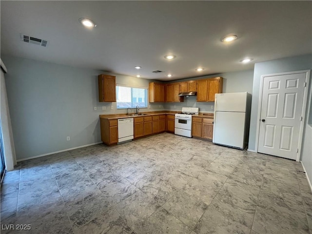 4749 Golden Shimmer Ave, Las Vegas, NV 89139 - kitchen featuring white appliances, under cabinet range hood, a sink, baseboards, and brown cabinets