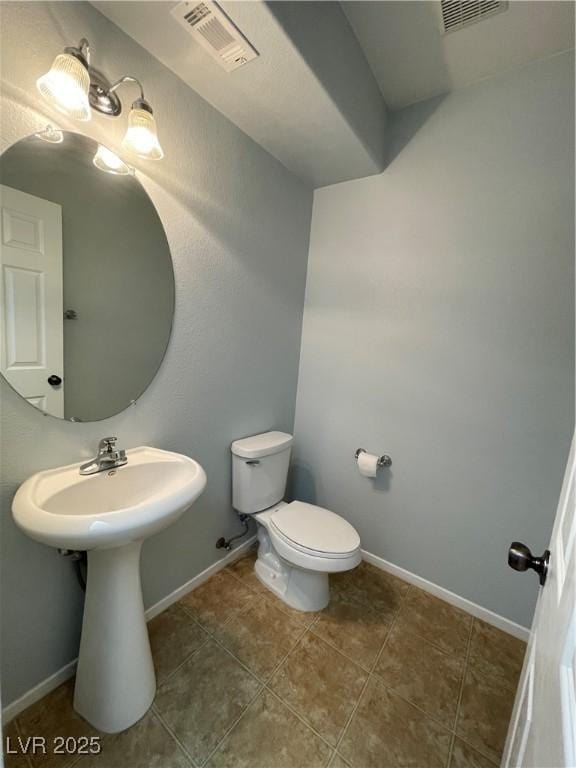 4749 Golden Shimmer Ave, Las Vegas, NV 89139 - half bathroom featuring toilet, tile patterned floors, baseboards, and a sink