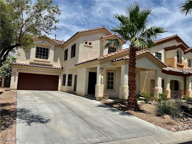 5524 Markley Ave, Las Vegas, NV 89141 - mediterranean / spanish house featuring concrete driveway, stucco siding, a garage, and a tile roof