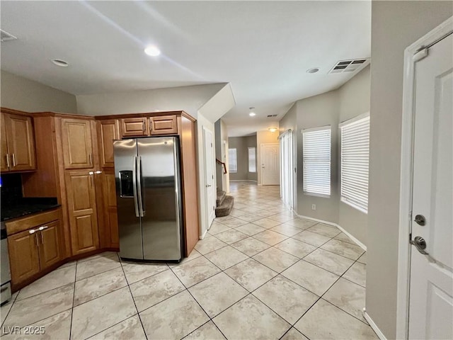 5524 Markley Ave, Las Vegas, NV 89141 - kitchen featuring stainless steel refrigerator with ice dispenser, light tile patterned floors, brown cabinets, recessed lighting, and baseboards