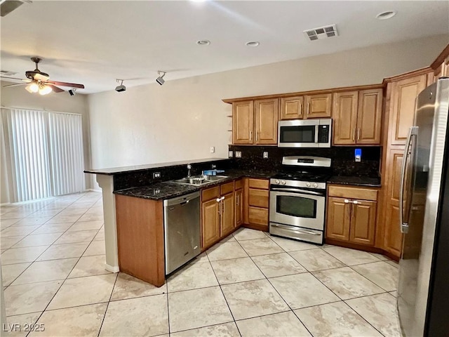 5524 Markley Ave, Las Vegas, NV 89141 - kitchen with appliances with stainless steel finishes, a sink, a peninsula, ceiling fan, and decorative backsplash