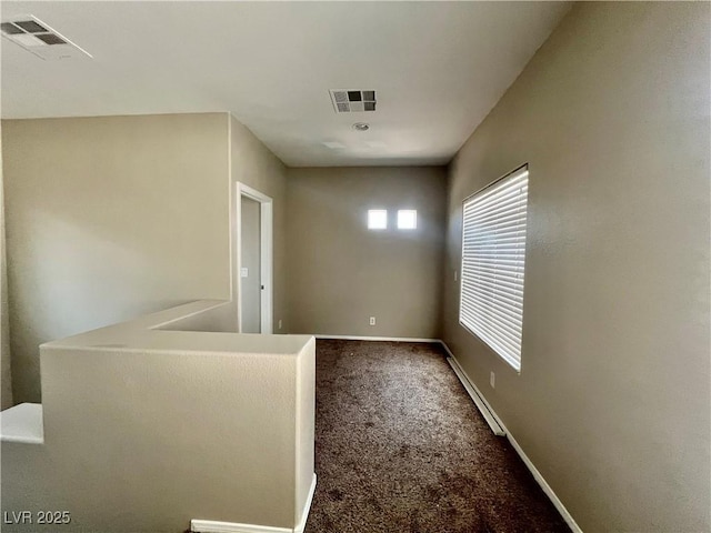 5524 Markley Ave, Las Vegas, NV 89141 - spare room with baseboard heating, dark colored carpet, and baseboards