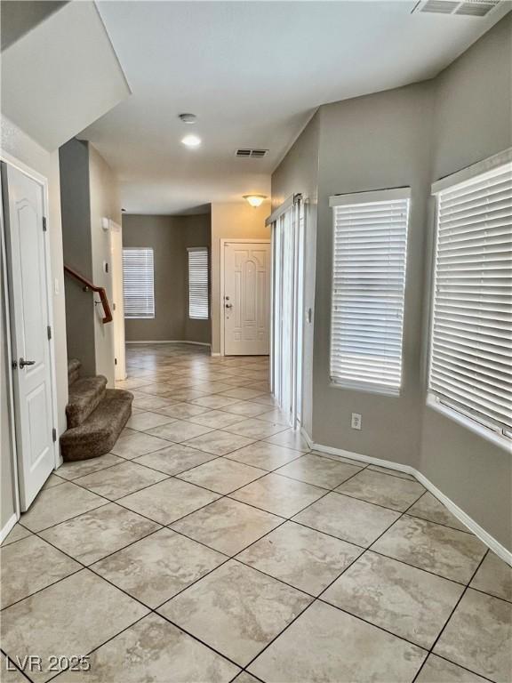 5524 Markley Ave, Las Vegas, NV 89141 - foyer entrance with light tile patterned floors, stairway, and baseboards