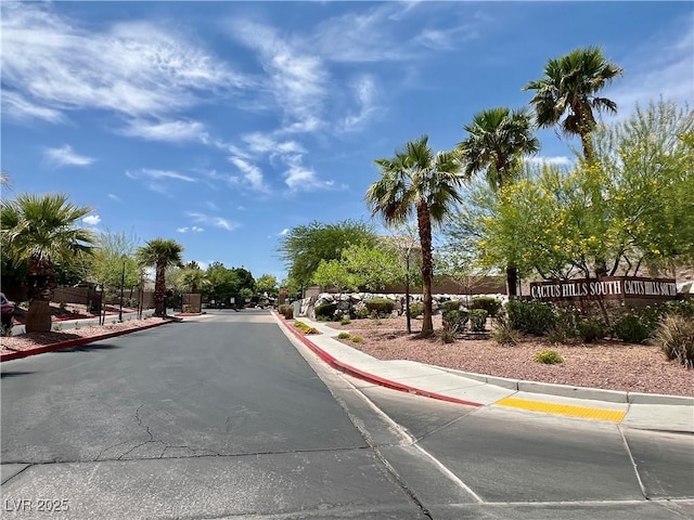 5524 Markley Ave, Las Vegas, NV 89141 - view of asphalt road with curbs, sidewalks, and a gated entry