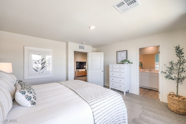 4972 Fern Mesa Ave Lot 133, Las Vegas, NV 89139 - bedroom with light colored carpet, ensuite bath, and baseboards