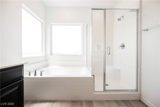 7002 Fossil Rim St, North Las Vegas, NV 89084 - full bathroom featuring a stall shower, a garden tub, wood finished floors, and vanity
