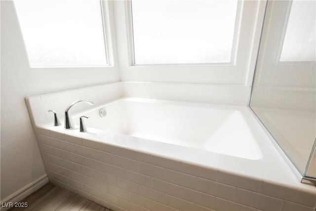 7002 Fossil Rim St, North Las Vegas, NV 89084 - bathroom featuring a garden tub and wood finished floors
