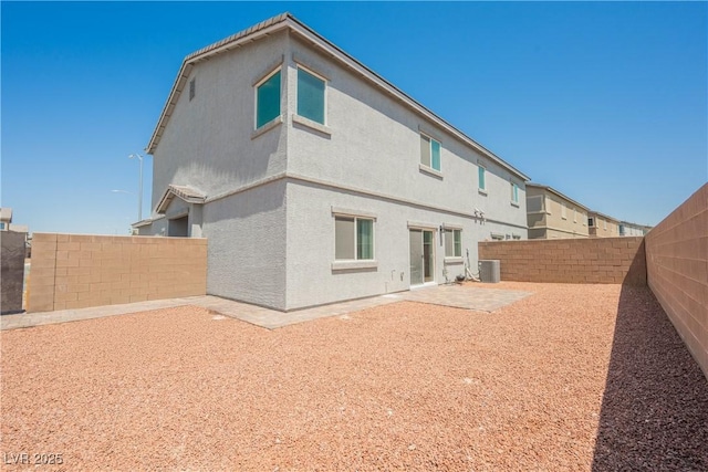 7002 Fossil Rim St, North Las Vegas, NV 89084 - rear view of house featuring a fenced backyard, central air condition unit, a patio, and stucco siding