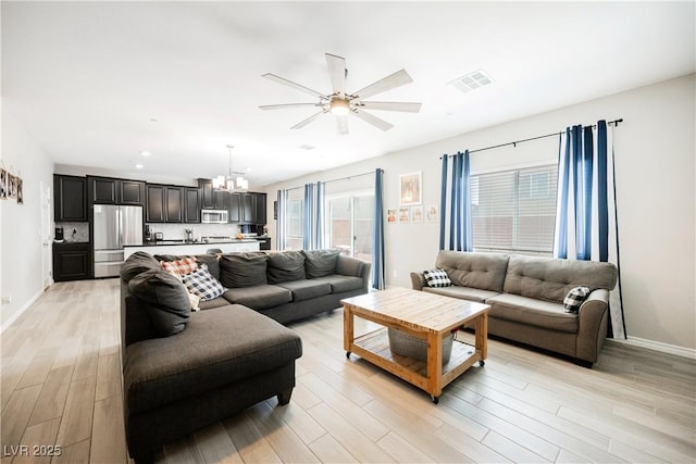 7002 Fossil Rim St, North Las Vegas, NV 89084 - living room featuring ceiling fan, a chandelier, light wood-style flooring, and recessed lighting