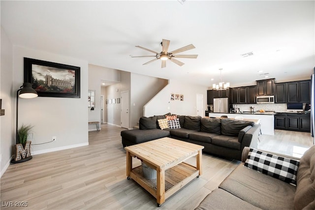 7002 Fossil Rim St, North Las Vegas, NV 89084 - living area featuring a chandelier, ceiling fan, light wood-type flooring, and baseboards