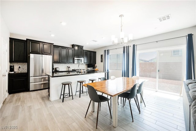 7002 Fossil Rim St, North Las Vegas, NV 89084 - dining space with a chandelier, light wood-style floors, and recessed lighting