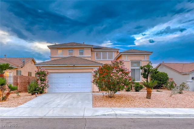 1367 Minuet St, Henderson, NV 89052 - view of front of property featuring concrete driveway, an attached garage, stucco siding, and solar panels