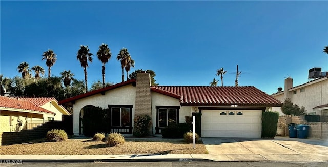 3729 La Junta Dr, Las Vegas, NV 89120 - mediterranean / spanish home featuring stucco siding, driveway, a garage, a chimney, and a tiled roof