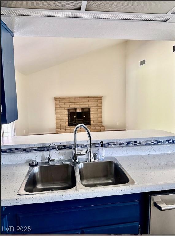 3729 La Junta Dr, Las Vegas, NV 89120 - kitchen with blue cabinetry, stainless steel dishwasher, and lofted ceiling