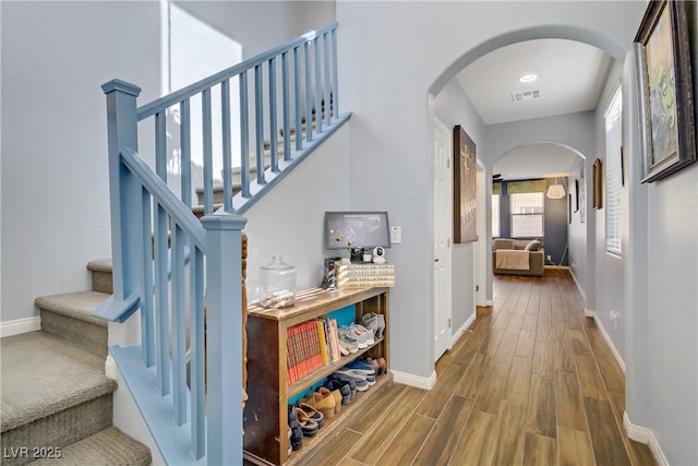 320 Point Loma Ave, North Las Vegas, NV 89031 - hall with arched walkways, wood finished floors, baseboards, and stairs