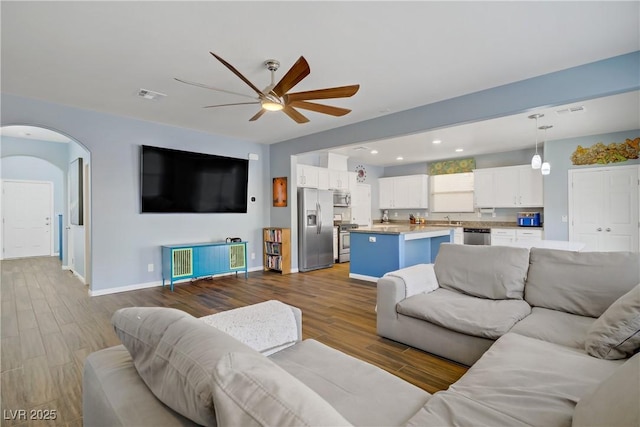 320 Point Loma Ave, North Las Vegas, NV 89031 - living area with a ceiling fan, wood finished floors, arched walkways, and baseboards