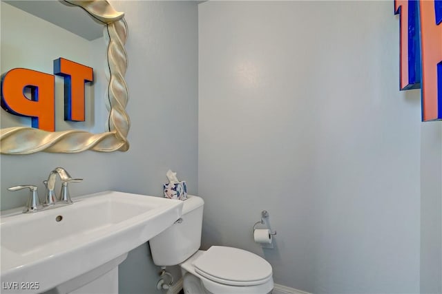 320 Point Loma Ave, North Las Vegas, NV 89031 - half bath with a sink, toilet, and baseboards
