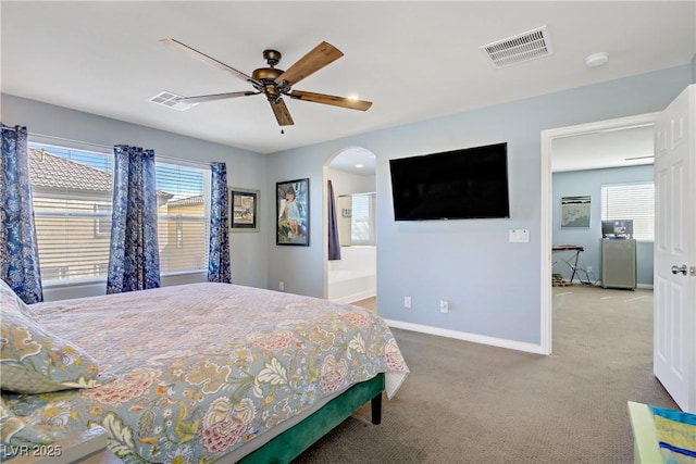 320 Point Loma Ave, North Las Vegas, NV 89031 - carpeted bedroom featuring multiple windows, baseboards, arched walkways, and a ceiling fan
