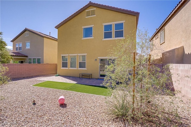 320 Point Loma Ave, North Las Vegas, NV 89031 - back of house with a fenced backyard, stucco siding, and a patio