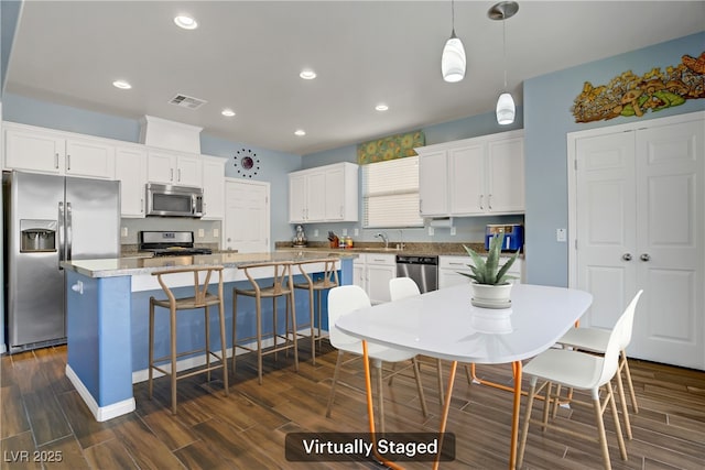 320 Point Loma Ave, North Las Vegas, NV 89031 - kitchen featuring appliances with stainless steel finishes, wood tiled floors, a sink, and recessed lighting