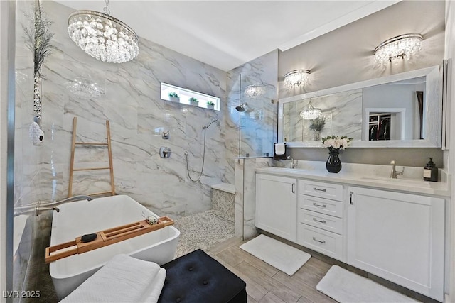 10484 Rose Park Ave, Las Vegas, NV 89135 - full bathroom featuring a marble finish shower, double vanity, a freestanding tub, wood finished floors, and a chandelier