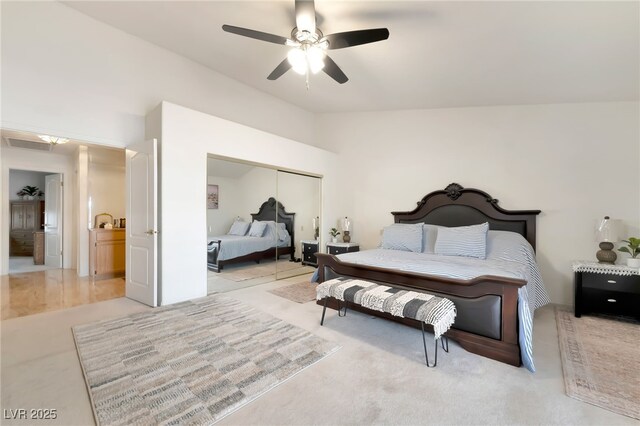 5829 W Patrick Ln, Las Vegas, NV 89118 - bedroom with vaulted ceiling, a closet, light colored carpet, and a ceiling fan