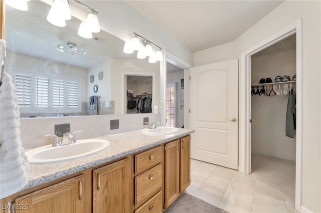 5829 W Patrick Ln, Las Vegas, NV 89118 - full bathroom with a spacious closet, double vanity, healthy amount of natural light, and tile patterned flooring