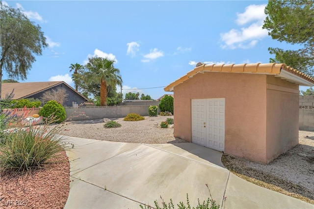 5829 W Patrick Ln, Las Vegas, NV 89118 - view of patio / terrace featuring concrete driveway and a detached garage