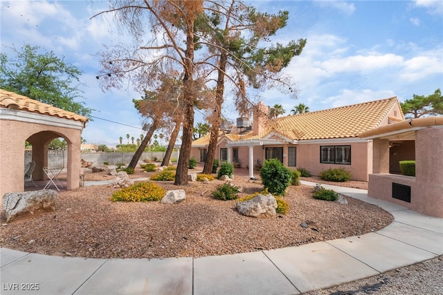 5829 W Patrick Ln, Las Vegas, NV 89118 - view of front of house with a tile roof, stucco siding, and a chimney