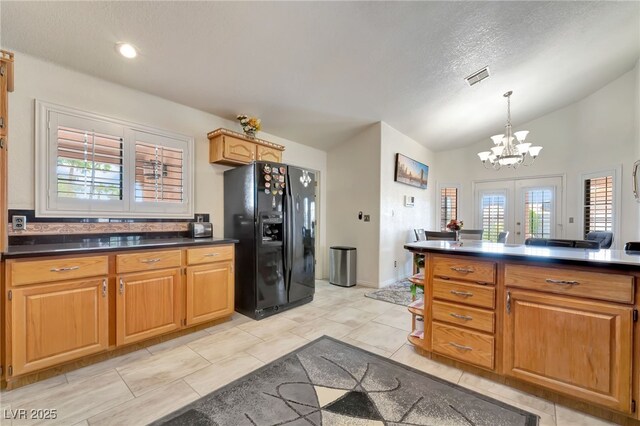 5829 W Patrick Ln, Las Vegas, NV 89118 - kitchen with black refrigerator with ice dispenser, dark countertops, a chandelier, vaulted ceiling, and french doors