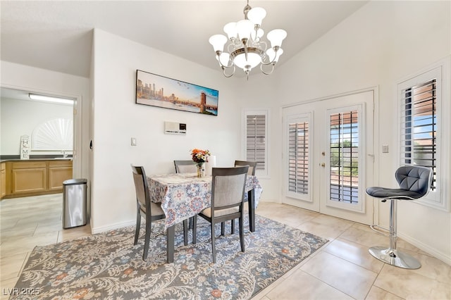 5829 W Patrick Ln, Las Vegas, NV 89118 - dining space with a chandelier, french doors, lofted ceiling, light tile patterned floors, and baseboards