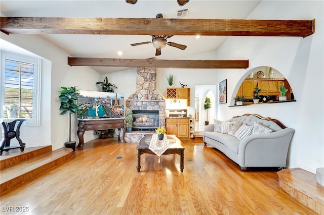 5829 W Patrick Ln, Las Vegas, NV 89118 - living room featuring light wood-type flooring, a ceiling fan, and a stone fireplace