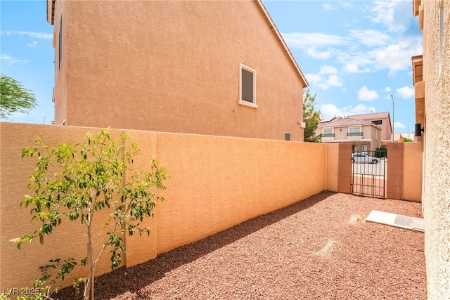 9704 Morgan Creek Ct, Las Vegas, NV 89141 - view of home's exterior featuring stucco siding and a gate