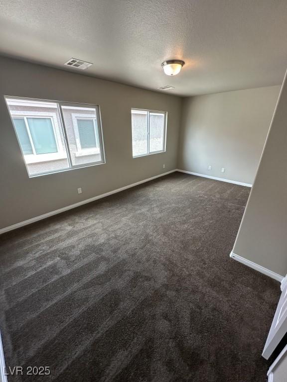 8116 Russell Creek Ct, Las Vegas, NV 89139 - spare room featuring dark carpet, baseboards, and a textured ceiling