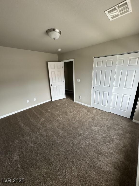 8116 Russell Creek Ct, Las Vegas, NV 89139 - unfurnished bedroom featuring baseboards, dark colored carpet, and a closet