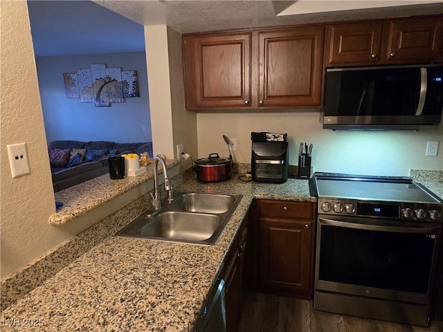 6800 E Lake Mead Blvd Unit 1126, Las Vegas, NV 89156 - kitchen with appliances with stainless steel finishes, a sink, dark wood finished floors, and a textured ceiling