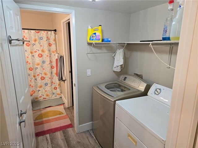 6800 E Lake Mead Blvd Unit 1126, Las Vegas, NV 89156 - washroom with washing machine and clothes dryer, wood finished floors, and baseboards