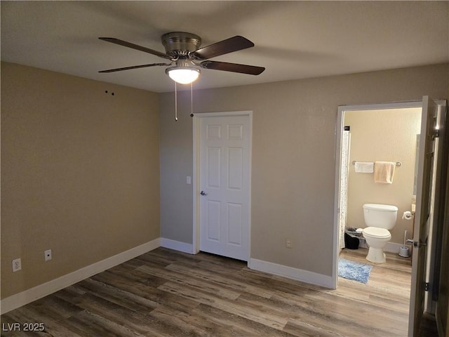 6800 E Lake Mead Blvd Unit 1126, Las Vegas, NV 89156 - unfurnished bedroom featuring wood finished floors, connected bathroom, baseboards, and a ceiling fan