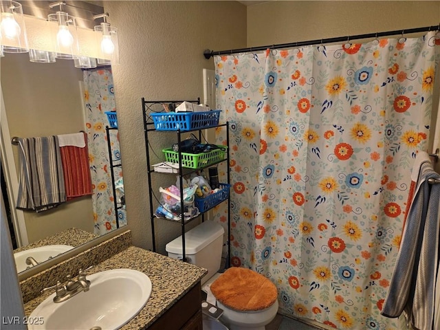 6800 E Lake Mead Blvd Unit 1126, Las Vegas, NV 89156 - bathroom with a textured wall, vanity, toilet, and curtained shower