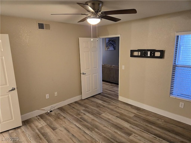 6800 E Lake Mead Blvd Unit 1126, Las Vegas, NV 89156 - unfurnished room featuring a ceiling fan, wood finished floors, and baseboards