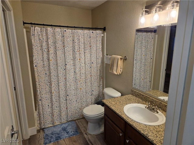 6800 E Lake Mead Blvd Unit 1126, Las Vegas, NV 89156 - full bathroom with wood finished floors, vanity, toilet, a textured wall, and a shower with curtain