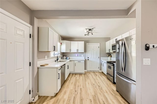 80 E Texas Ave, Henderson, NV 89015 - kitchen featuring appliances with stainless steel finishes, a sink, light wood-style floors, and light countertops