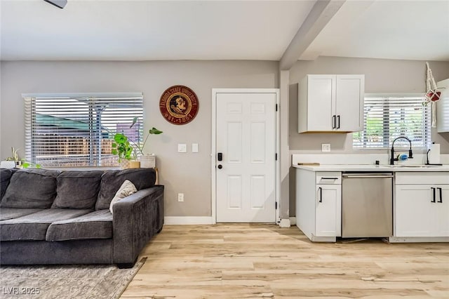 80 E Texas Ave, Henderson, NV 89015 - kitchen featuring dishwasher, a sink, open floor plan, light wood-type flooring, and white cabinets