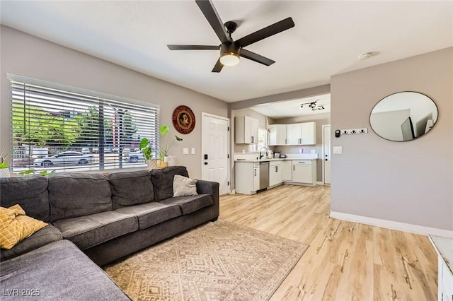 80 E Texas Ave, Henderson, NV 89015 - living area with a ceiling fan, light wood-type flooring, healthy amount of natural light, and baseboards