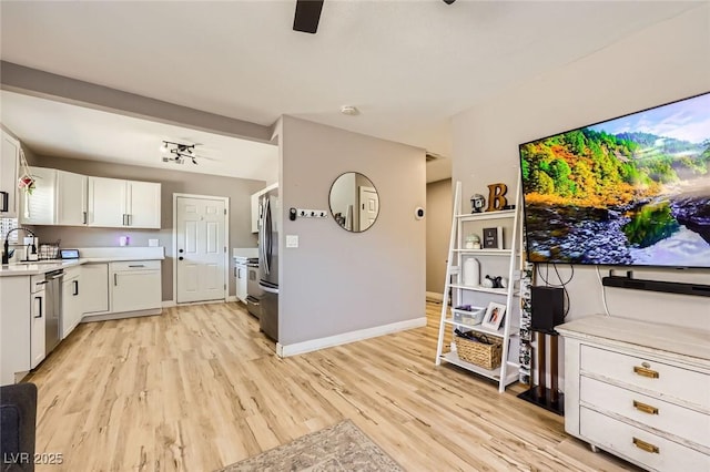 80 E Texas Ave, Henderson, NV 89015 - kitchen featuring light wood-type flooring, stainless steel appliances, white cabinets, light countertops, and baseboards